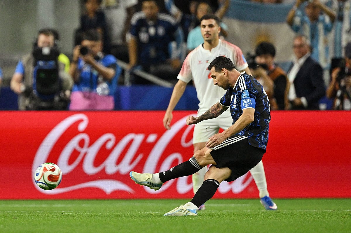 Argentina's Lionel Messi scores their third goal from a free kick
