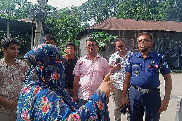 Police investigators speak with local residents following the killings of a mother and her three daughters.