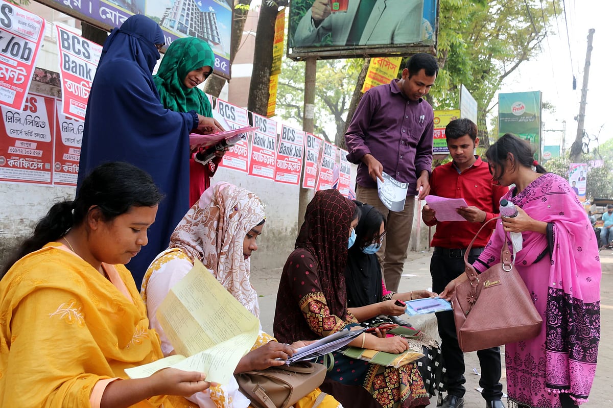 A group of BCS exam candidates discussing the question papers with their friends after taking the exam. Rangpur Zilla School