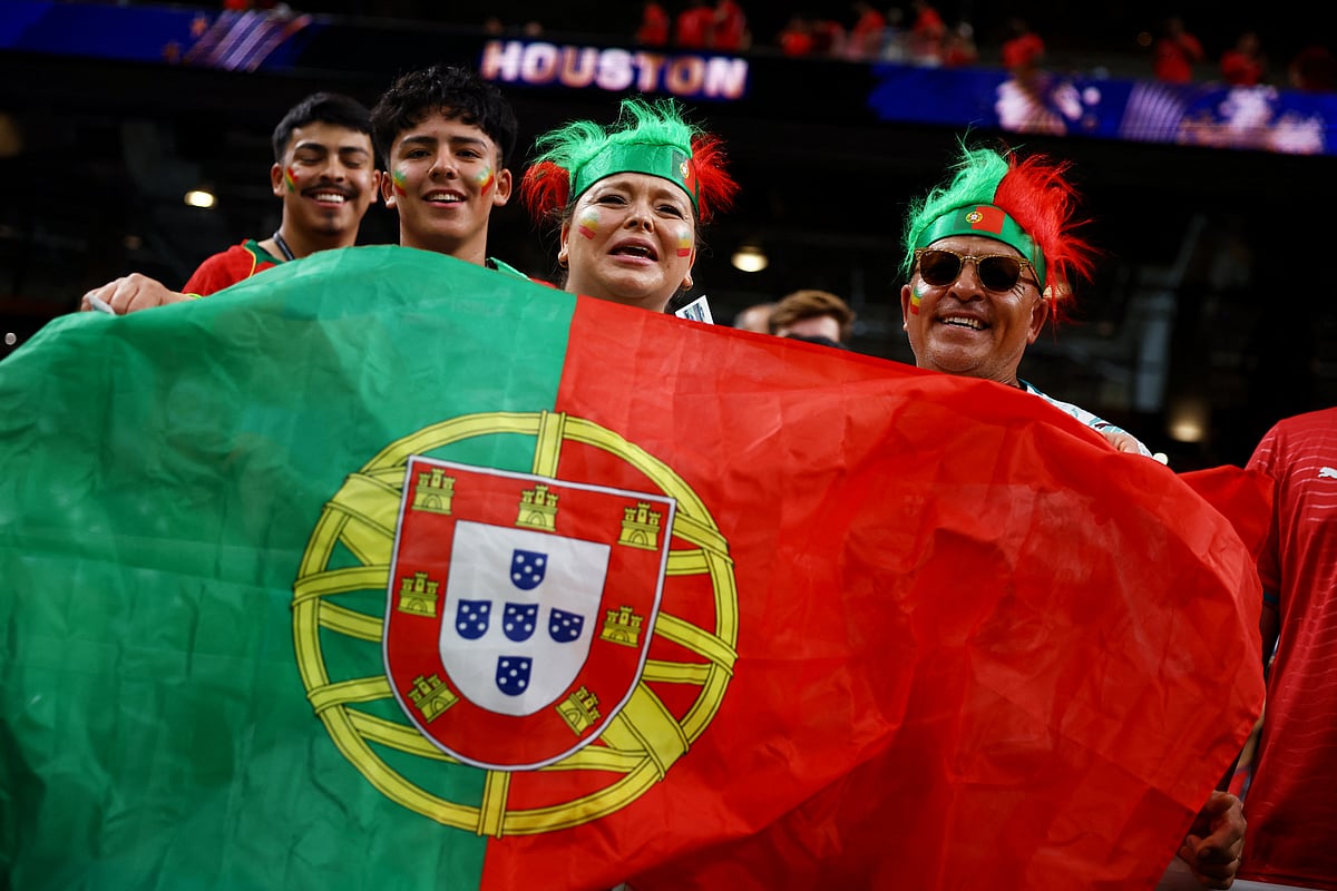 Football - FIFA World Cup 2026 - Group K - Portugal v Uzbekistan - Houston Stadium, Houston, Texas, U.S. - June 23, 2026
Portugal fans pose for a photo with their national flag inside the stadium before the match