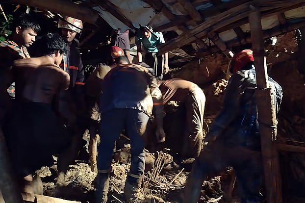Fire Service personnel conduct rescue operations following the landslides early Monday.