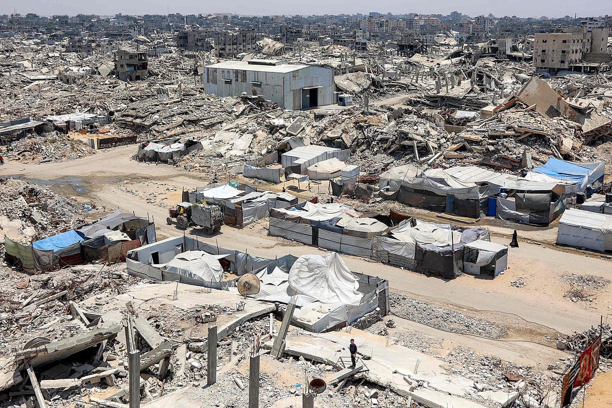 Tents and shelters are pictured next to rubble of collapsed buildings at a camp for people displaced by war in the Sheikh Radwan neighbourhood of Gaza City on 6 July 2026
