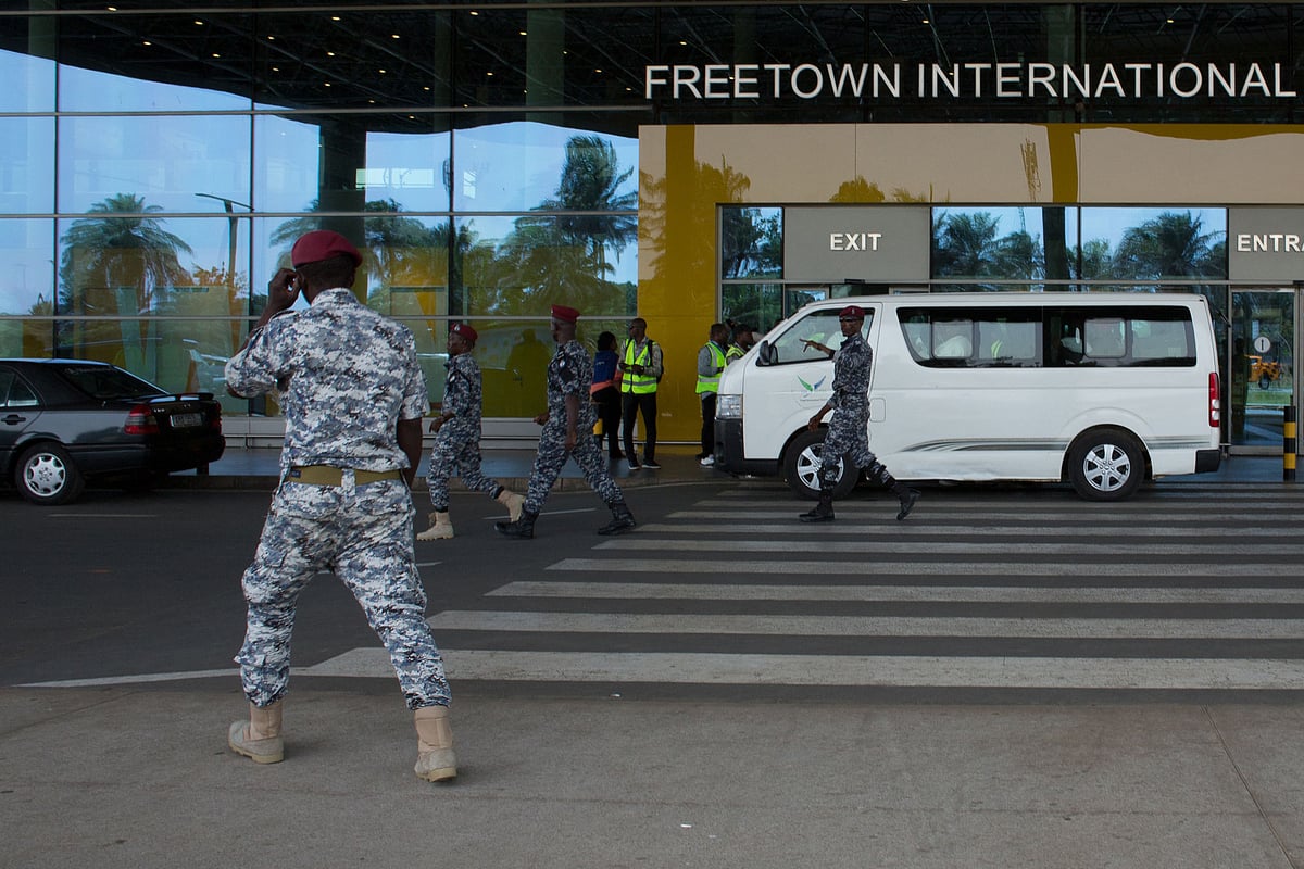 Security escort migrants in a National Public Health Agency (NPHA) after their arrival at Freetown International Airport, formerly known as Lungi International Airport, in Lungi on 20 May, 2026.