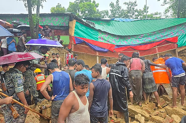 Volunteers, Rohingya residents and officials carry out rescue operations after a wall of a madrasa collapsed, killing three female students at Rohingya Camp-5 in Ukhiya, Cox's Bazar, on Wednesday.