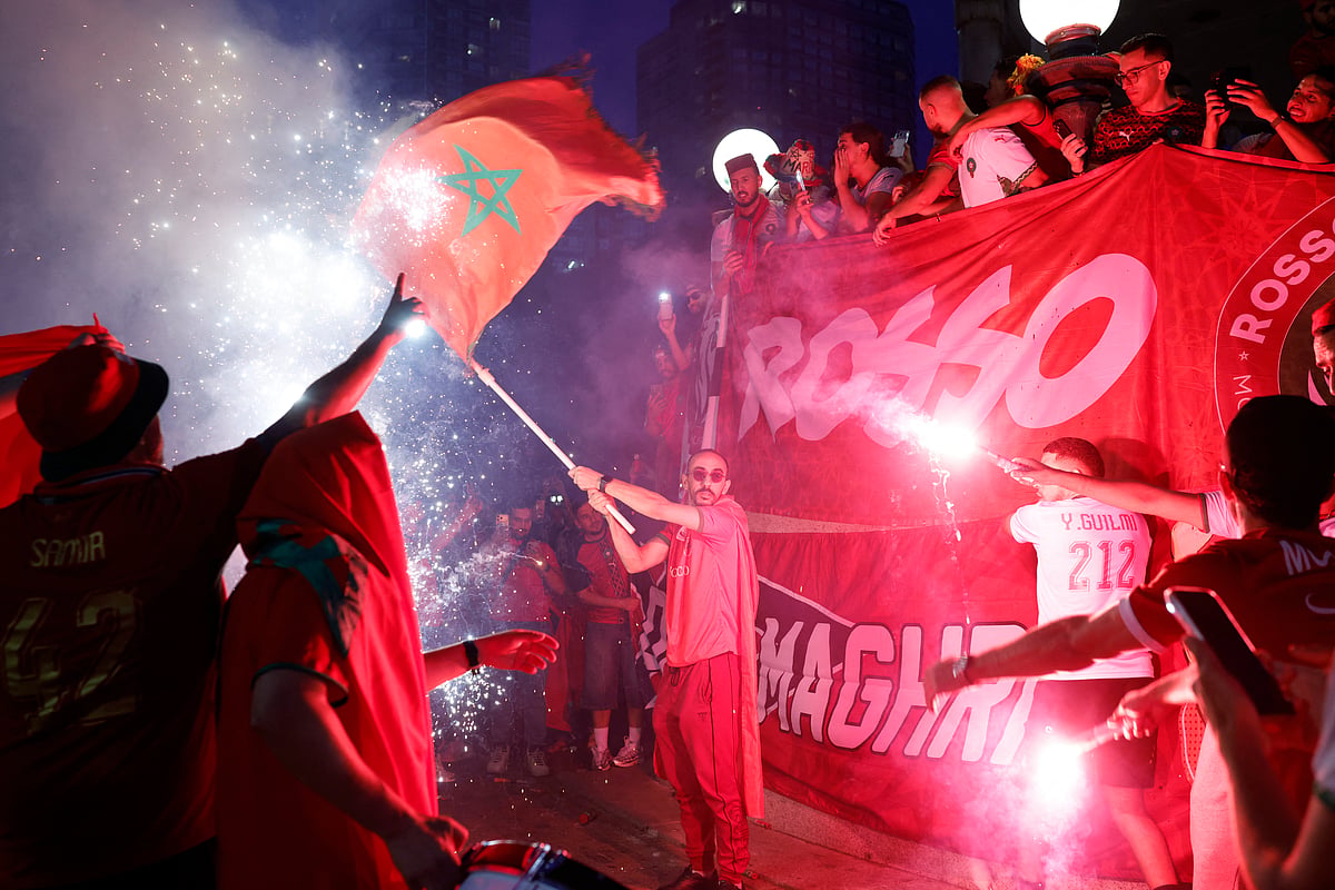 Morocco fans light flares as they gather on Boston Common ahead of their game against France