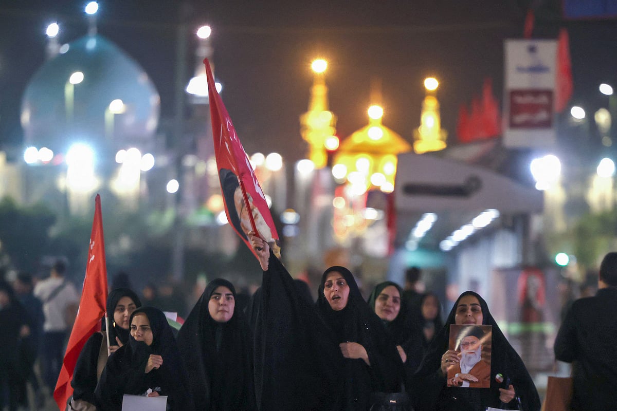 Mourners walk along a street as they arrive to attend the funeral of slain Iranian leader Ali Khamenei and members of his family near Imam Reza's shrine in Mashhad early on July 9, 2026. Iranians were preparing on July 9 to bury their slain leader Ali Khamenei in his hometown of Mashhad in northeast Iran, as new US strikes threatened to trigger a fresh escalation in the Middle East war. The late supreme leader's burial follows a multi-day funeral ceremony that attracted millions of mourners across various cities in both Iran and Iraq.