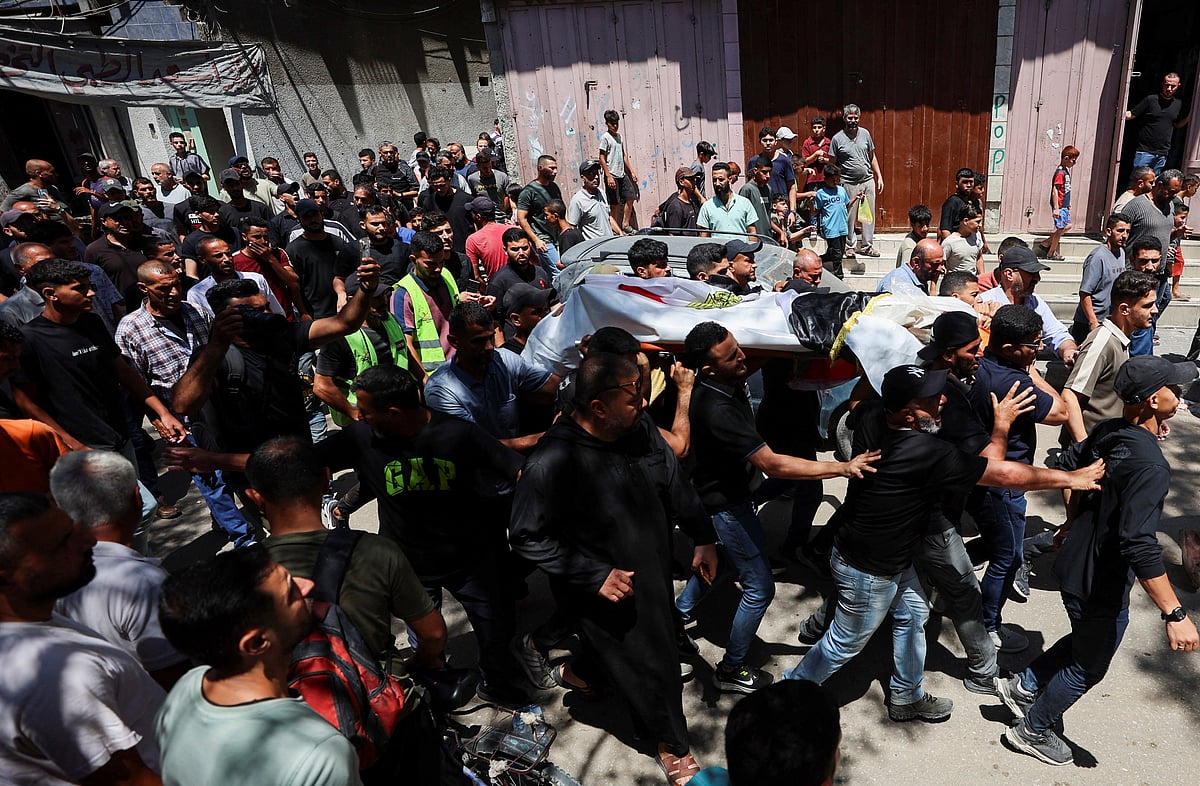 Mourners carry the body of Palestinian man Mohammad al-Waheidi, who worked for the Egyptian Relief Committee and was killed in an Israeli strike on Tuesday, during his funeral, in Gaza City, July 8, 2026