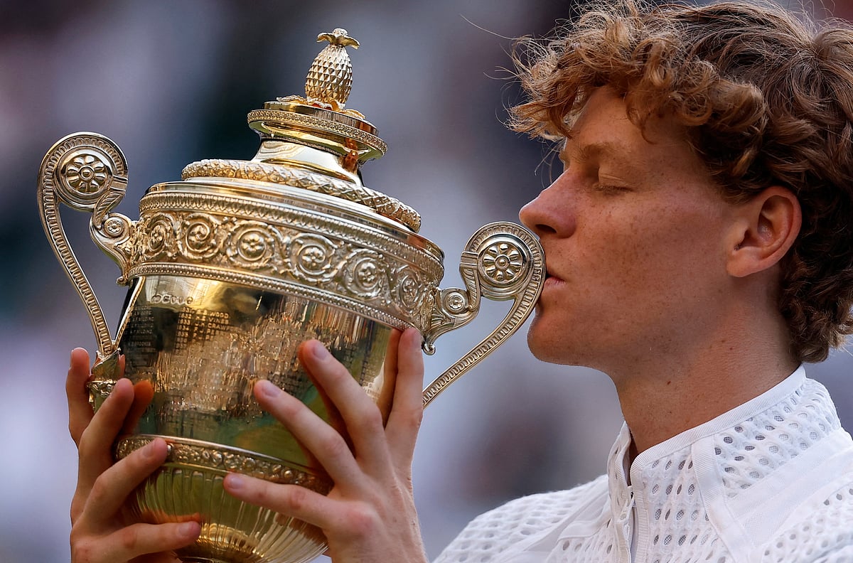 Italy's Jannik Sinner celebrates with the trophy after winning his final match against Germany's Alexander Zverev at  Wimbledon - All England Lawn Tennis and Croquet Club, London, Britain - July 12, 2026.