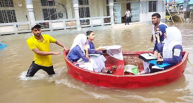 Cumilla Government Women's College is a center for HSC exams. The college premises were submerged in heavy rain. Therefore, the city authorities arranged to take the examinees to the center in plastic boats. Cumilla, 13 July, 2026
