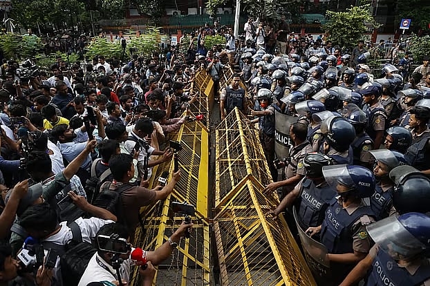 Student protesters face a police barricade outside the Education Building in Dhaka.