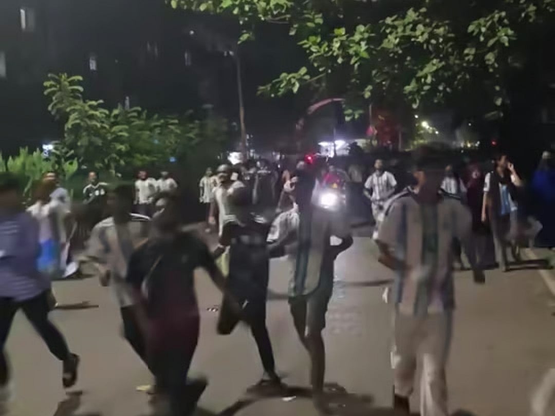 People break through barricades to enter the Dhaka University campus to watch the FIFA World Cup final on 20 July 2026.