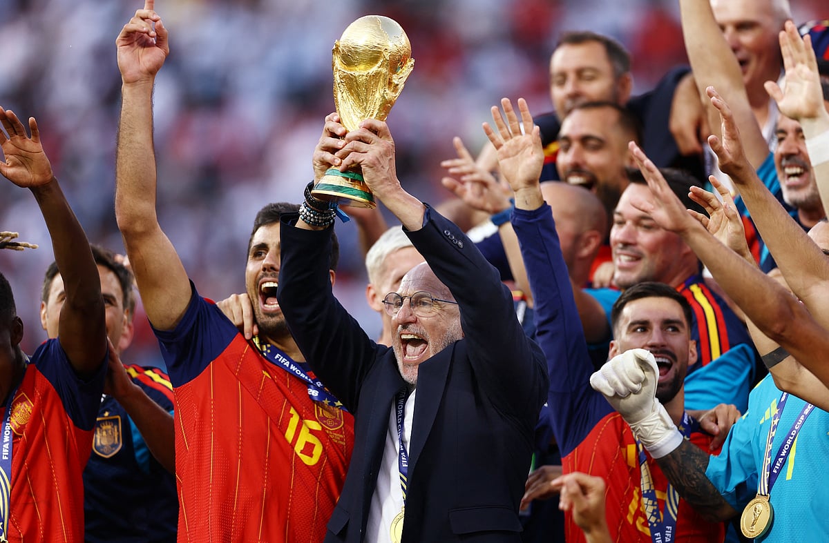 Spain coach Luis De La Fuente lifts the World Cup trophy alongside the players as they celebrate winning the World Cup