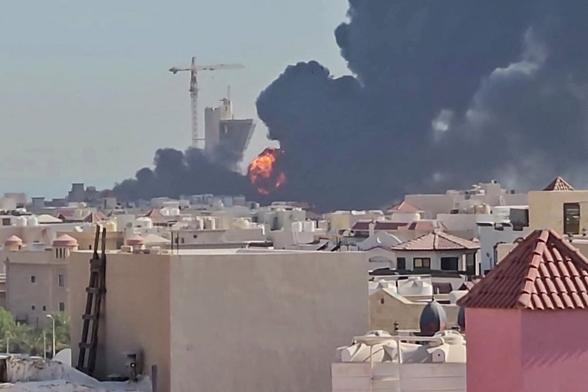 This screen grab taken from UGC video footage posted on social media on July 18, 2026, shows a plume of black smoke and flames billowing over the town of Mangaf, south of Kuwait City. Kuwait accused Iran on July 18 of targeting civilian sites and vital infrastructure in the country, after reporting attacks on an oil facility and a power and water plant.