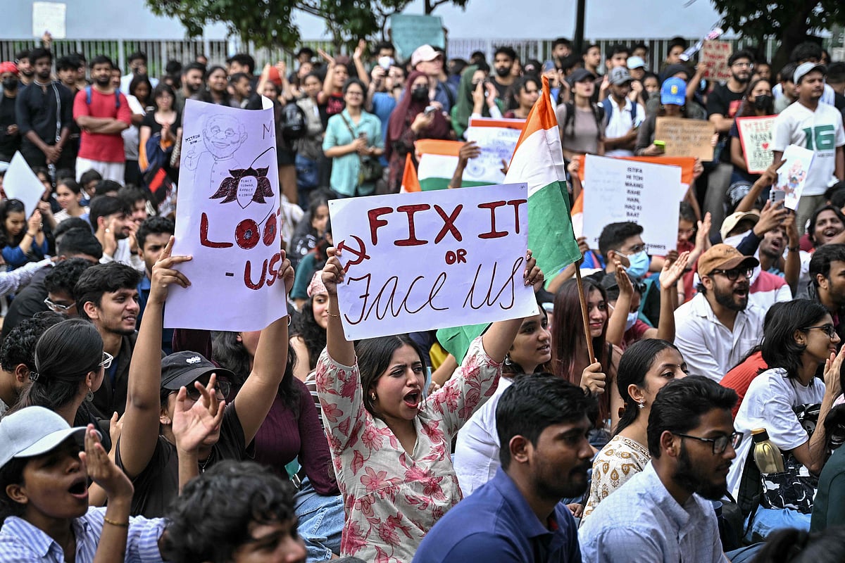 Demonstrators hold placards during a protest at Freedom Park in Bengaluru on 22 July 2026 in solidarity with the ongoing protest at New Delhi's Jantar Mantar demanding the resignation of India's Education Minister Dharmendra Pradhan over alleged NEET exam irregularities. The protests, led by the social media-driven Cockroach Janta Party (CJP) movement, have emerged as one of the biggest challenges to Prime Minister Narendra Modi's government since his re-election in 2024.