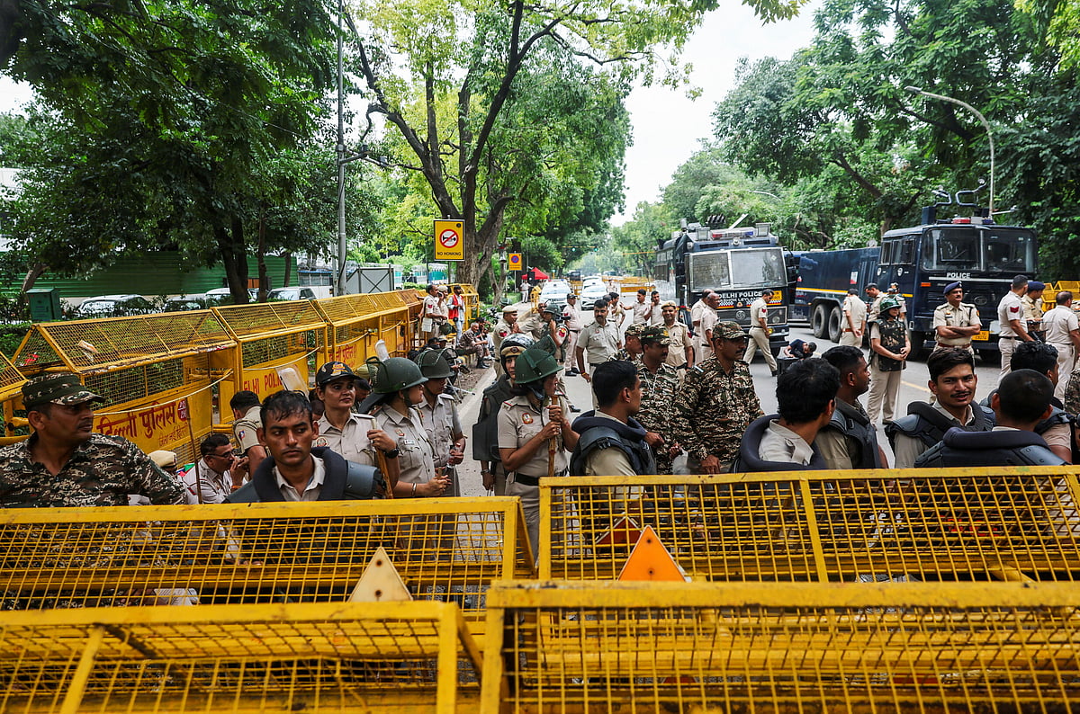 Police personnel stand guard outside Minister of Education of India Dharmendra Pradhan's residence, as supporters of India's Cockroach Janata Party (CJP) demonstrate during the ongoing protests, a few days after thousands of protesters marched towards parliament demanding the resignation of Education Minister over National Eligibility cum Entrance Test (NEET) examination paper leaks, in New Delhi, India, 23 July, 2026.