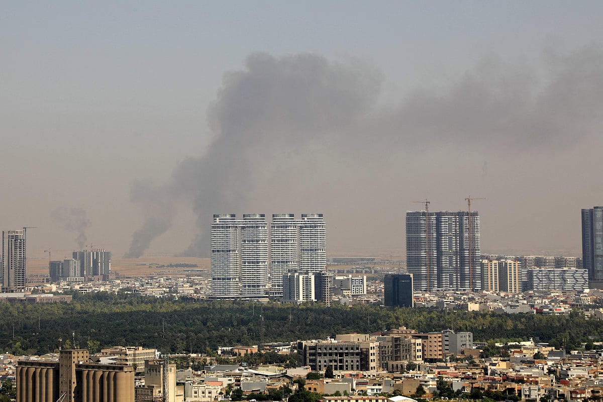 Smoke rises after explosions were heard and air defences activated near the airport in Erbil, on July 24, 2026. Several blasts sounded on July 24 near Erbil airport, which hosts US-led coalition troops in Iraq's autonomous Kurdistan region, an AFP journalist said.