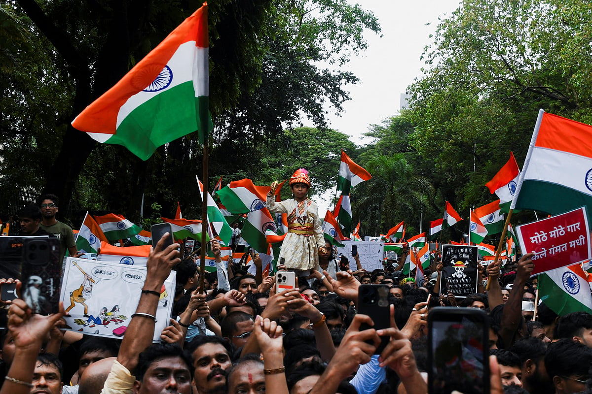 Cockroach Janta Party (CJP) supporters chant slogans, hold placards and wave national flag as they celebrate the resignation of Education Minister Dharmendra Pradhan over the National Eligibility cum Entrance Test (NEET) examination paper leaks, following a protest, in Mumbai, India, 26 July, 2026.