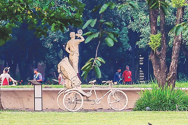 A sculpture depicting rickshaw puller Md Sujon Khan saluting student protesters while standing on his rickshaw near Doel Chattar at the University of Dhaka during the Anti-Discrimination Student Movement stands on the grounds of the July Mass Uprising Memorial Museum. The photo was taken yesterday afternoon in Sher-e-Bangla Nagar, Dhaka.