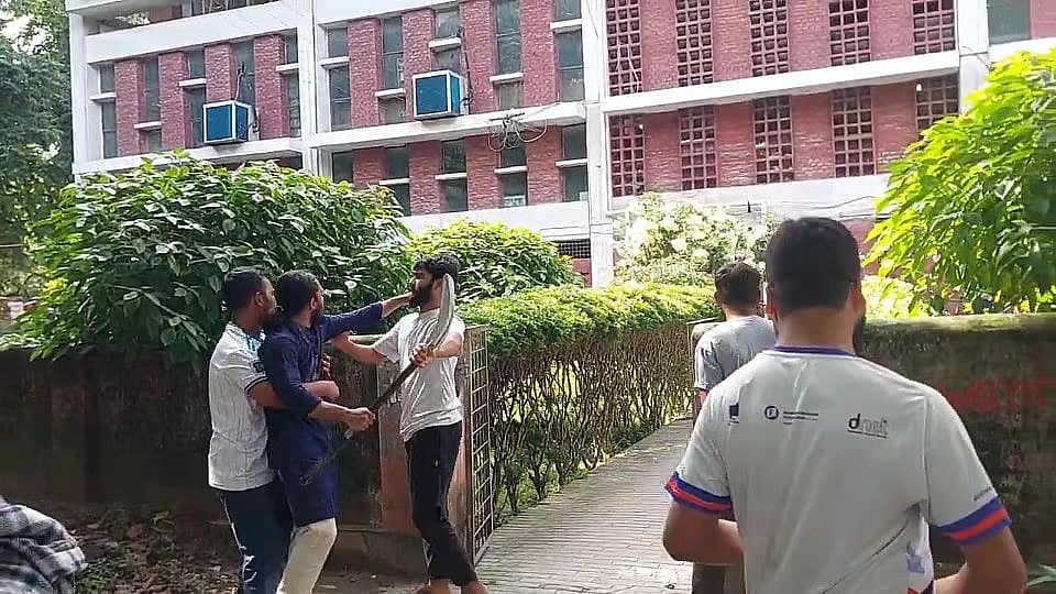 RUCSU GS Salahuddin Ammar rushes towards the central library of Rajshahi University with a shovel in his hand on 27 July 2026 afternoon.