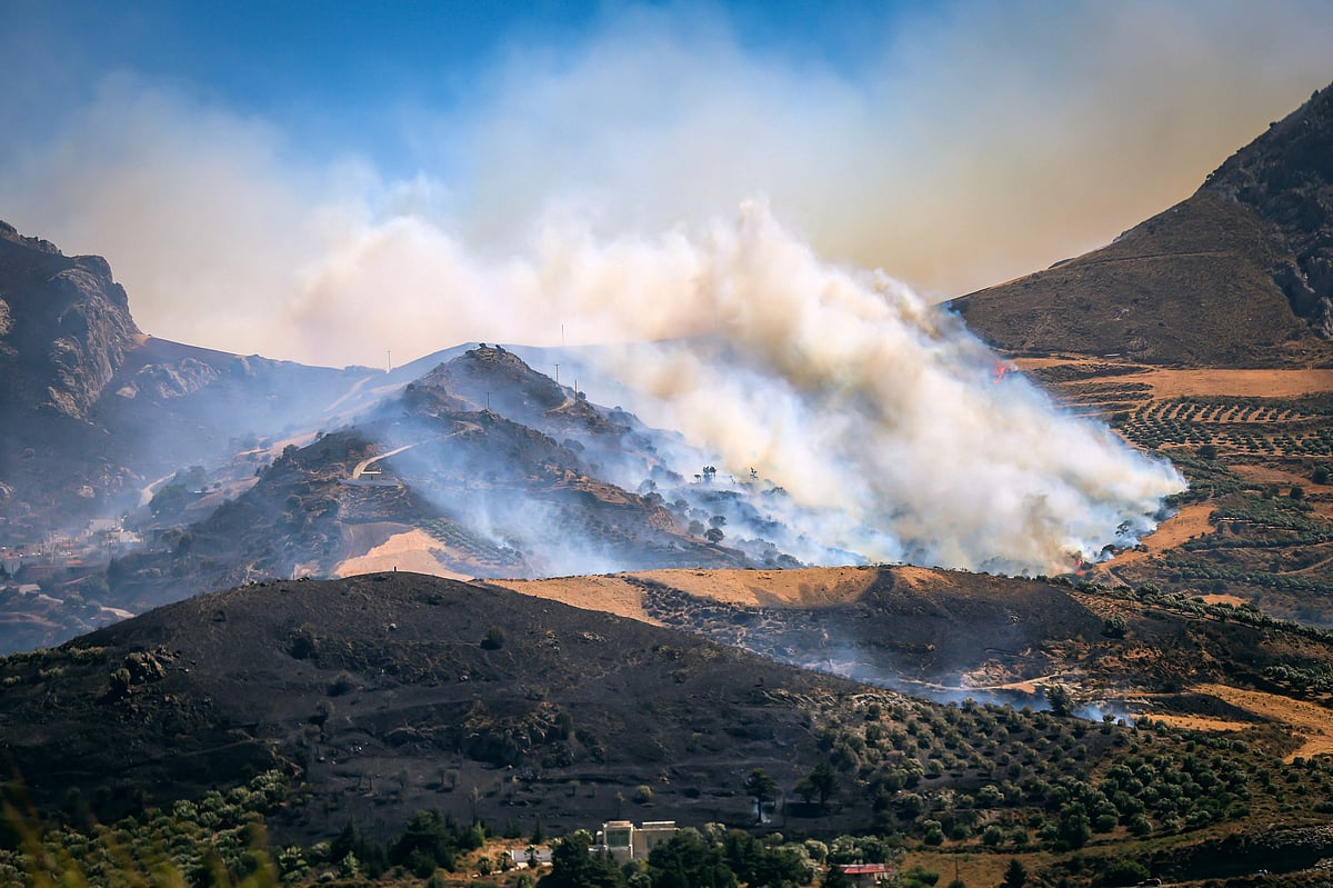 This photograph shows a burning area during a wildfire near the village of Asomatos in the Greek island of Crete on 30 July, 2026.