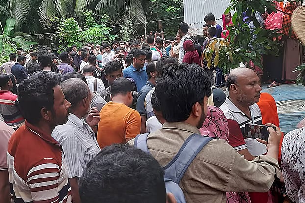 After the recovery of three bodies from the same house at Kachua in Bagerhat, there is a crowd of people at the house. The photo was taken on Tuesday afternoon in Chandarkola village, Radipara Union, Kachua Upazila. 