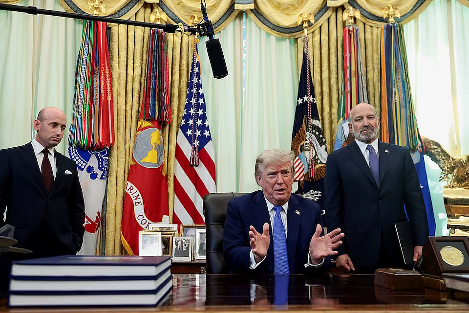 US President Donald Trump, with White House Deputy Chief of Staff Stephen Miller and US Secretary of Commerce Howard Lutnick, speaks during an event to sign executive orders related to birthright citizenship and the polysilicon industry, in the Oval Office at the White House in Washington, DC, US, 6 August, 2026.