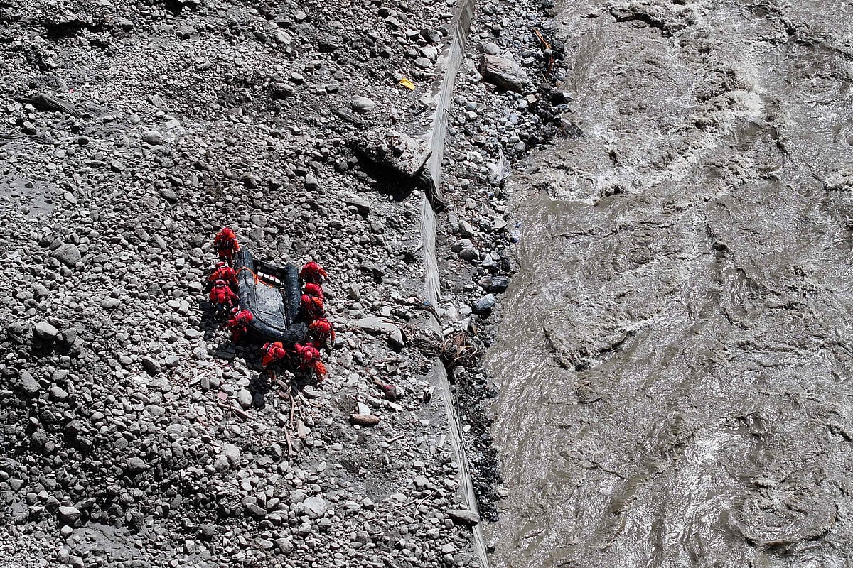Fire and rescue personnel conduct search and rescue operations at Gyirong Port, which was destroyed by a mudslide two days earlier, in Gyirong County, in Chinas western Tibet region on 28 August 2026.