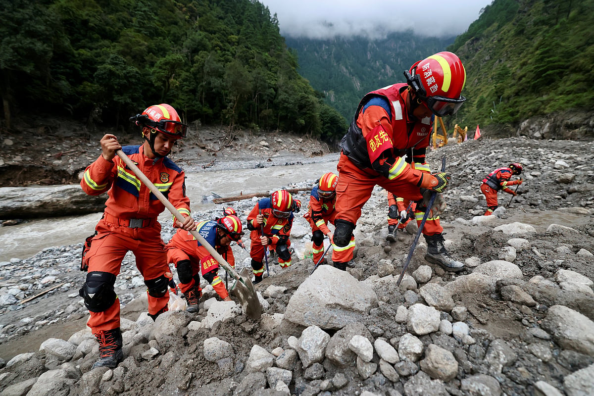 Rescue workers clear debris during search operations near the Gyirong port after a mudslide, in Shigatse, Tibet Autonomous Region, China August 29, 2026.