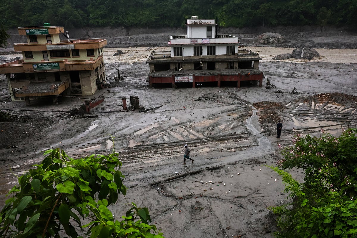 A man walks past damaged buildings after the flash floods and mudslide, at Trishuli, Nuwakot district, Nepal, 29 August 2026.