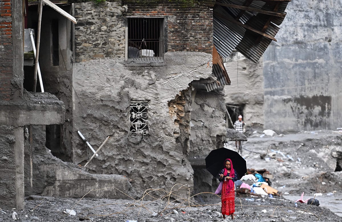 A woman walks among the ruins of flash floods in Nepal's Nuwakot district on 1 September 2026