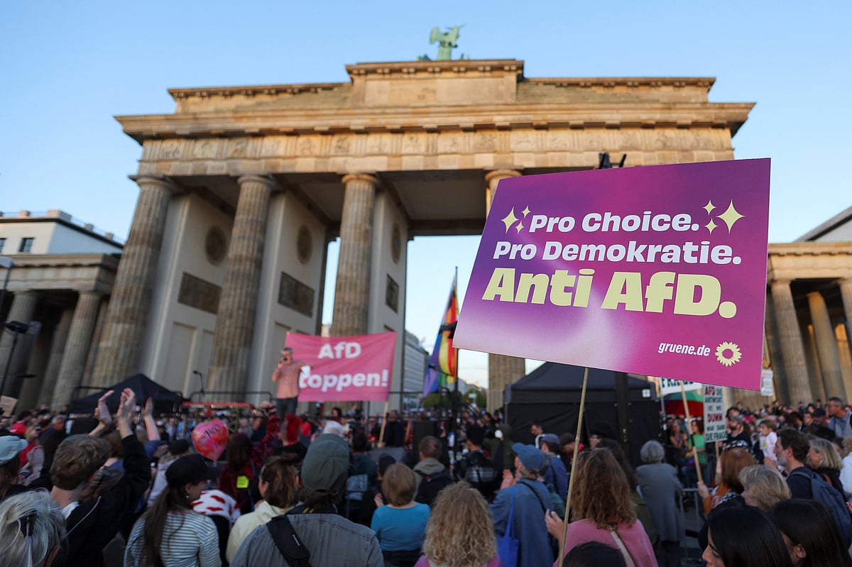 Demonstrators hold banners during a protest the day after the victory of the far-right Alternative for Germany (AfD) party in state elections in Saxony-Anhalt at the Brandenburg Gate in Berlin, Germany, 7 September, 2026.