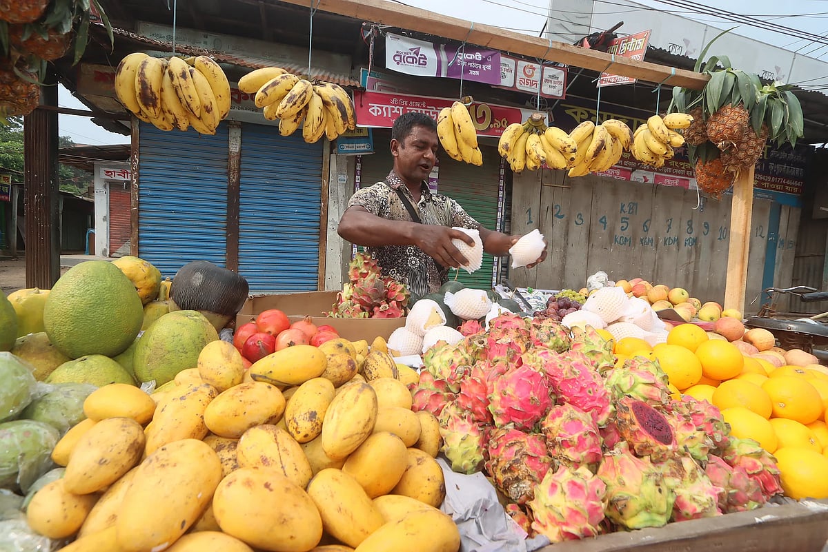 A man arrives to sell an assortment of seasonal fruits arranged on a cycle van. In front of Shaheed Jorrej Market, Rangpur, 8 September 2026.