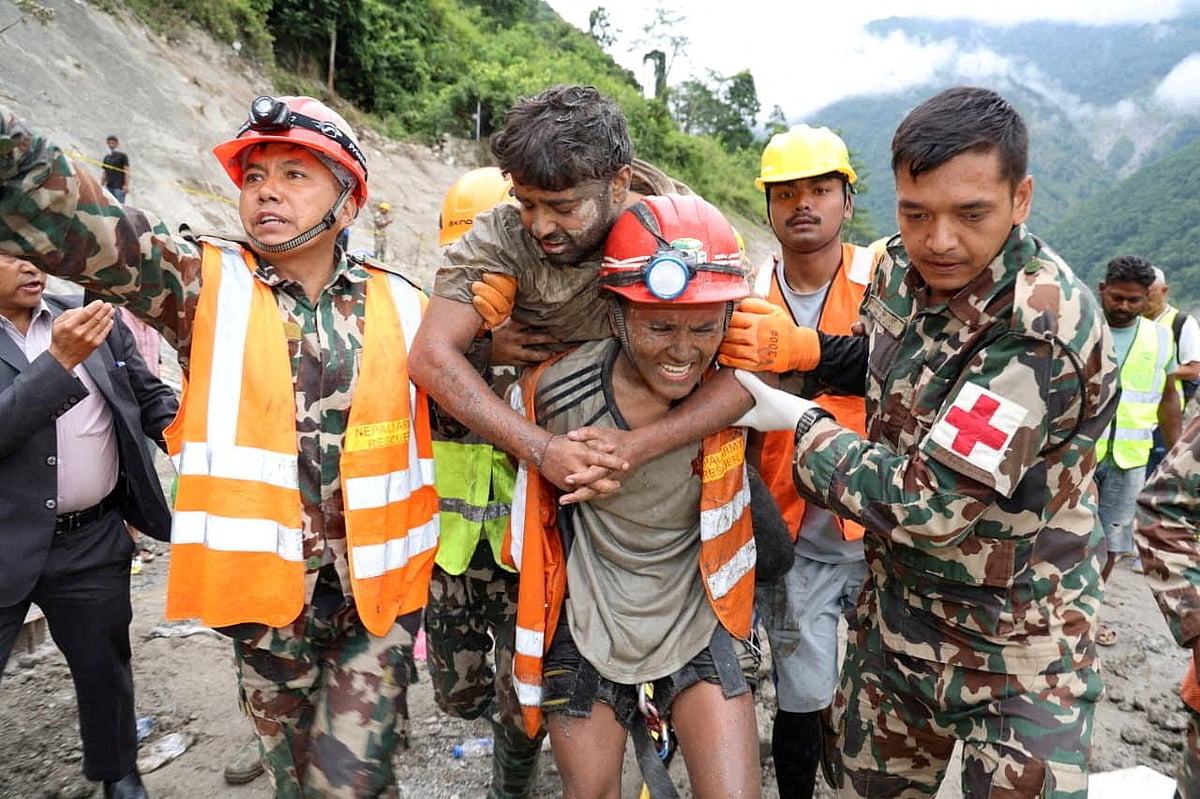 Sanjay Sah is carried by members of a search and rescue team after being one of two people rescued alive from a tunnel at the Trishuli-3A Hydropower Project, where two people had been trapped following devastating floods and mudslides that struck the Bhotekoshi River in Rasuwa, Nepal, 4 September, 2026.