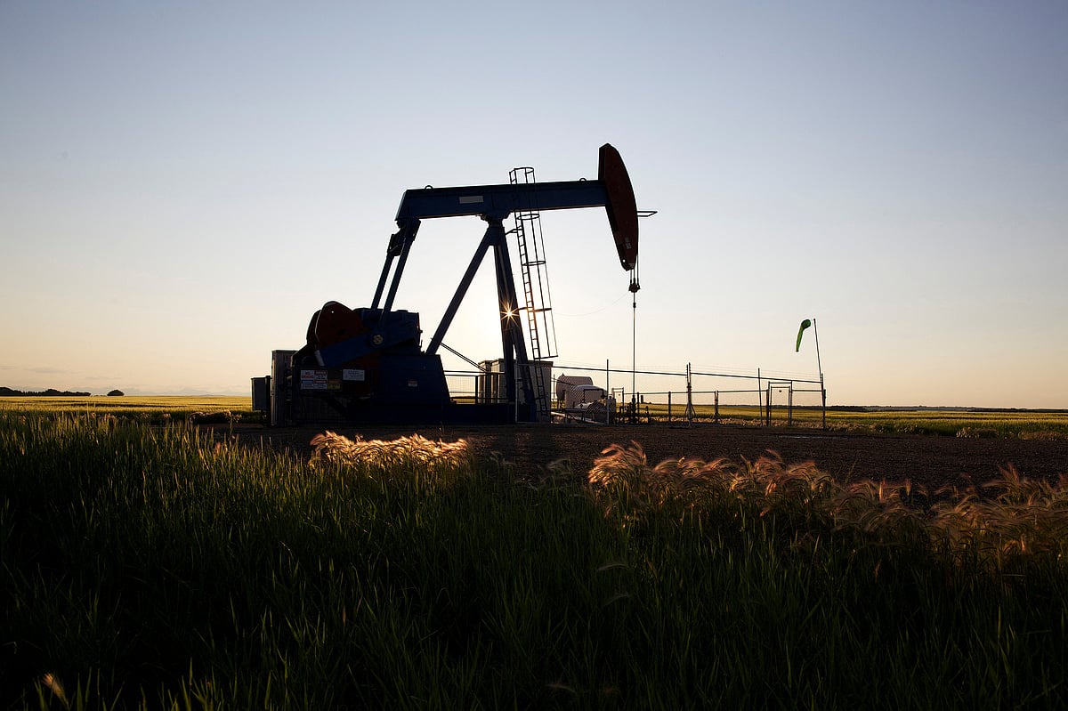 An oil pump jack pumps oil in a field near Calgary, Alberta, 21 July, 2014. Pump jacks are used to pump crude oil out of the ground after an oil well has been drilled.