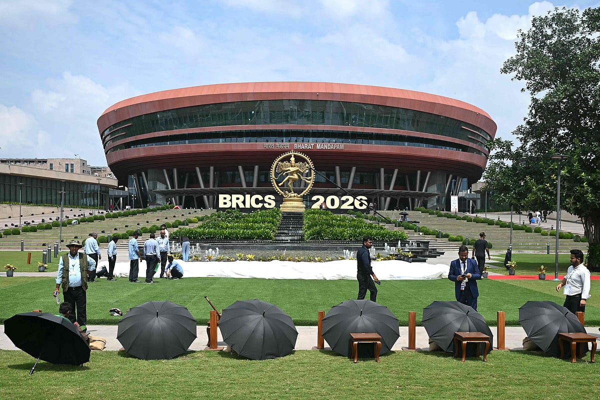 Officials prepare an area for the group photograph of leaders at the venue of the 18th BRICS Summit in New Delhi on 12 September 2026.