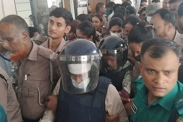 Gazi Nazrul Islam and his first wife are taken to a Dhaka court on Monday. They were taken away after the remand hearing.