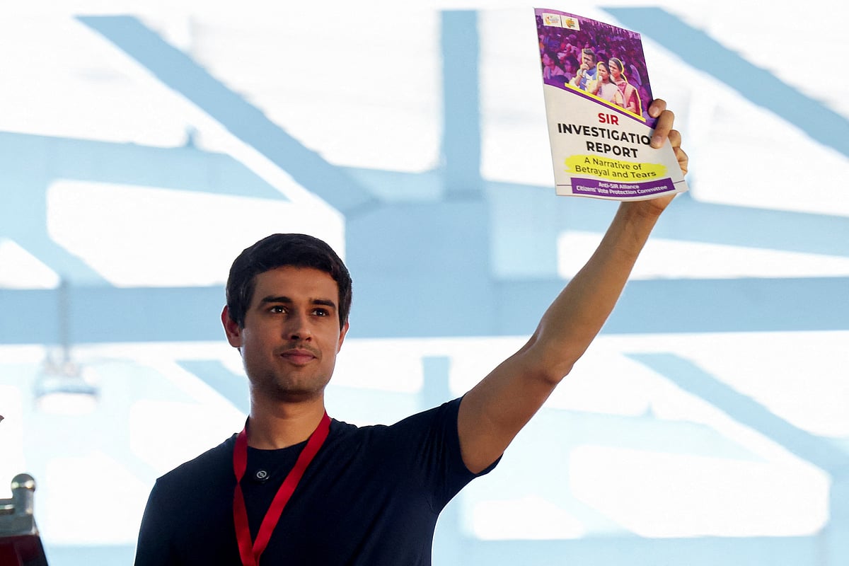Indian social media influencer and activist Dhruv Rathee shows a SIR (Special Intensive Revision) investigation report copy to people during a protest demanding the resignation of India's Chief Election Commissioner Gyanesh Kumar, in Bengaluru, India, 8 October 2026.