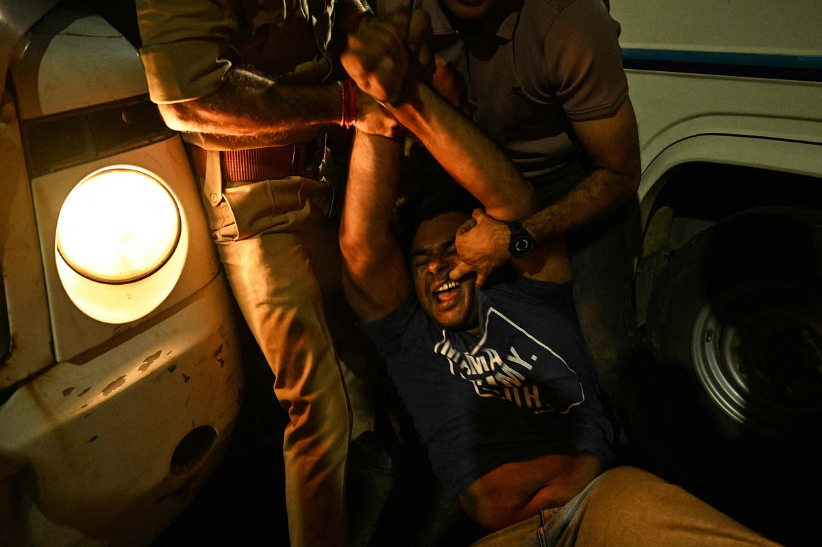 Police personnel detain a supporter of the Cockroach Janata Party (CJP) during a protest demanding the resignation of Indias Chief Election Commissioner Gyanesh Kumar over alleged voter roll irregularities linked to the "special intensive revision" (SIR), in Ahmedabad on 10 October, 2026. 