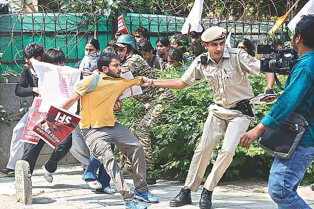 A police officer drags away a protester demonstrating for the resignation of the Chief Election Commissioner. The photograph was taken yesterday in New Delhi, the capital of India.