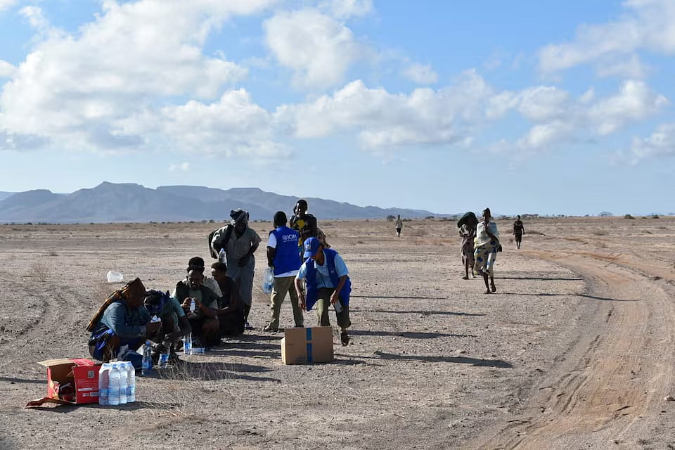 International Organization for Migration workers receive migrants after a boat carrying about 305 people capsized.