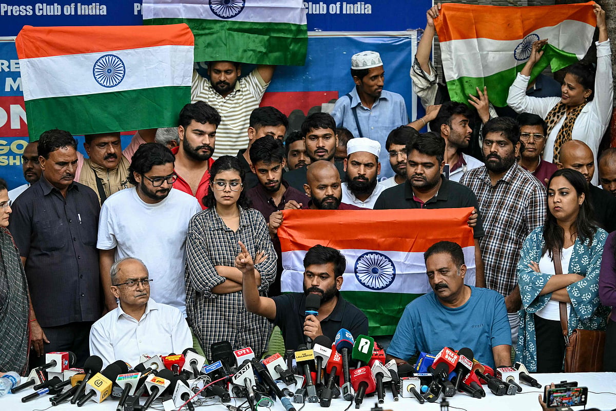 Cockroach Janta Party (CJP) founder Abhijeet Dipke (C) along with Indian actor and activist Prakash Raj (R) and Indian lawyer and activist Prashant Bhushan (L) addresses the media during a press conference in New Delhi on October 15, 2026 amid ongoing protests against India's Chief Election Commissioner Gyanesh Kumar over alleged voter roll irregularities linked to the "special intensive revision" (SIR). CJP founder Dipke called on people to gather on October 16 in Connaught Place, close to Jantar Mantar. CJP activists and opposition parties have defied a security crackdown to demand the resignation of India's chief election commissioner, accusing the poll body of manipulating voter rolls to benefit Prime Minister Narendra Modi's ruling party. (Photo by Arun SANKAR / AFP)