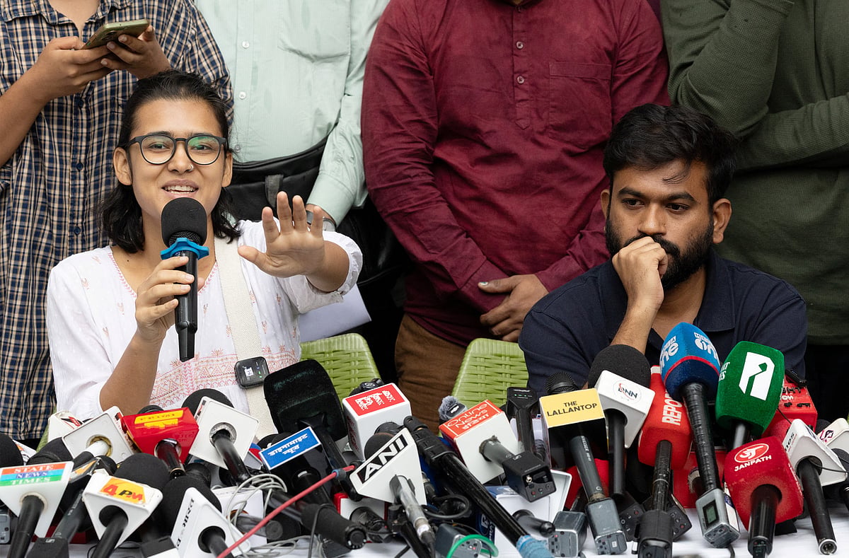 Abhijeet Dipke, founder of the Cockroach Janata Party (CJP) and Neha Bora, national president of the All India Students' Association (AISA) gesture as they addresses a press conference in New Delhi, India, 15 October 2026. 