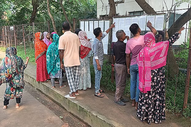Several workers look at a list of employees laid off by Keya Group in Gazipur. The photo was taken in the Jarun area of Konabari on September 8