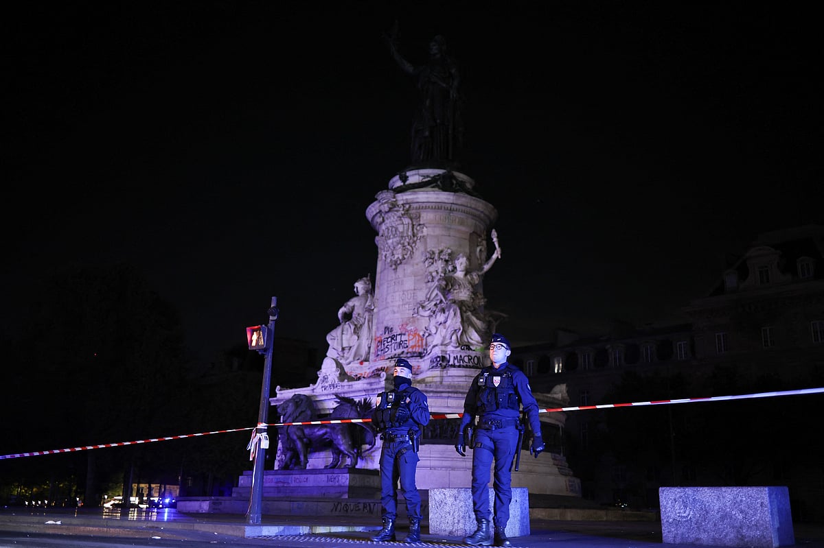 Police officers stand guard at Place de la Republique during a partial curfew in Paris on 20 October, 2026, following weekend demonstrations over soaring prices degenerated into some of the worst street violence in recent years.