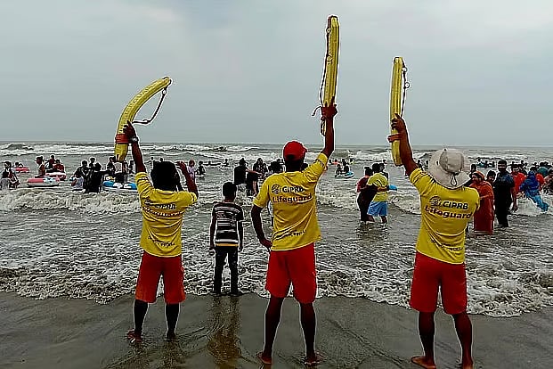 Lifeguards work to rescue tourists swept away by the current while bathing in the sea at Cox’s Bazar beach.