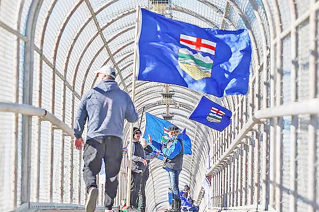 A supporter of Alberta independence holding a flag