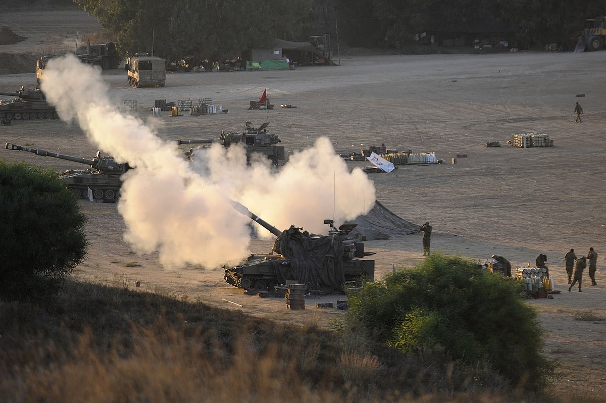 An Israeli tank fires a 155mm shell towards targets in the Gaza Strip from their position near Israel's border with the Palestinian enclave on July 23, 2014.
