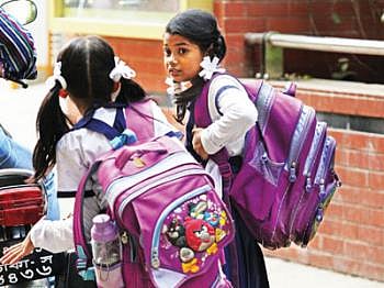 Students carrying heavy schoolbags