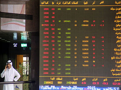 A Kuwaiti trader follows the stock market activity at the Kuwait Stock Exchange (KSE) in Kuwait City.