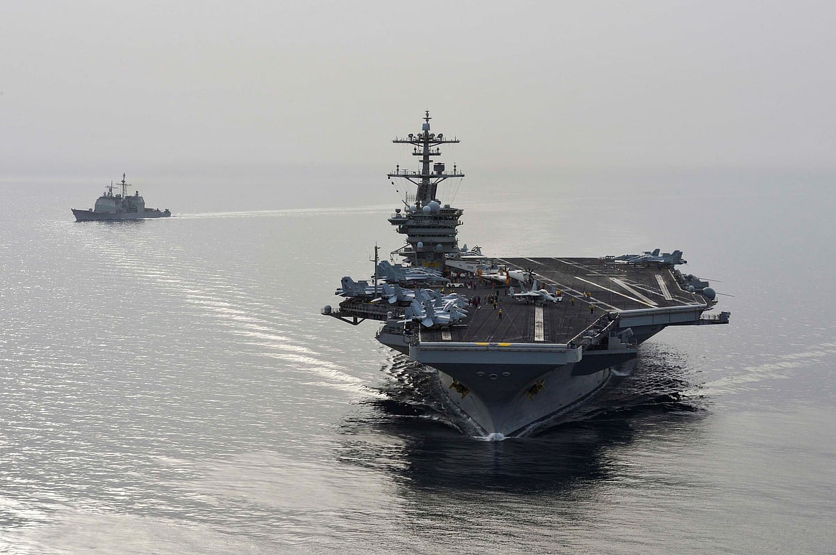 This US Navy photo obtained April 21, 2015 shows the aircraft carrier USS Theodore Roosevelt (CVN 71) and the guided-missile cruiser USS Normandy (CG) 60 as they sail in the US 5th Fleet area of operations on 16 April 2015.